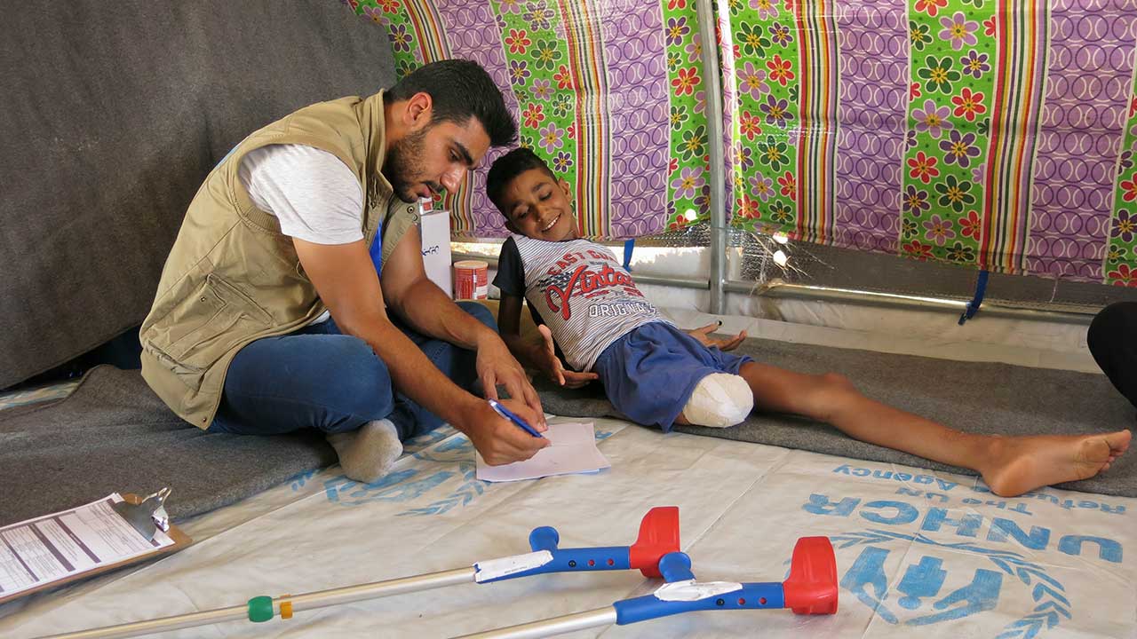 Physio Mohammad with Adbel Rahman, who lost his leg in a bombing, Mosul.