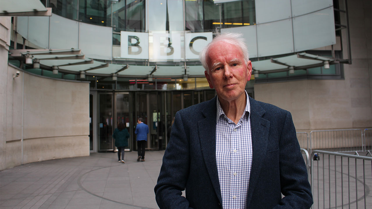 Broadcaster and journalist Mike Wooldridge standing outside the BBC.